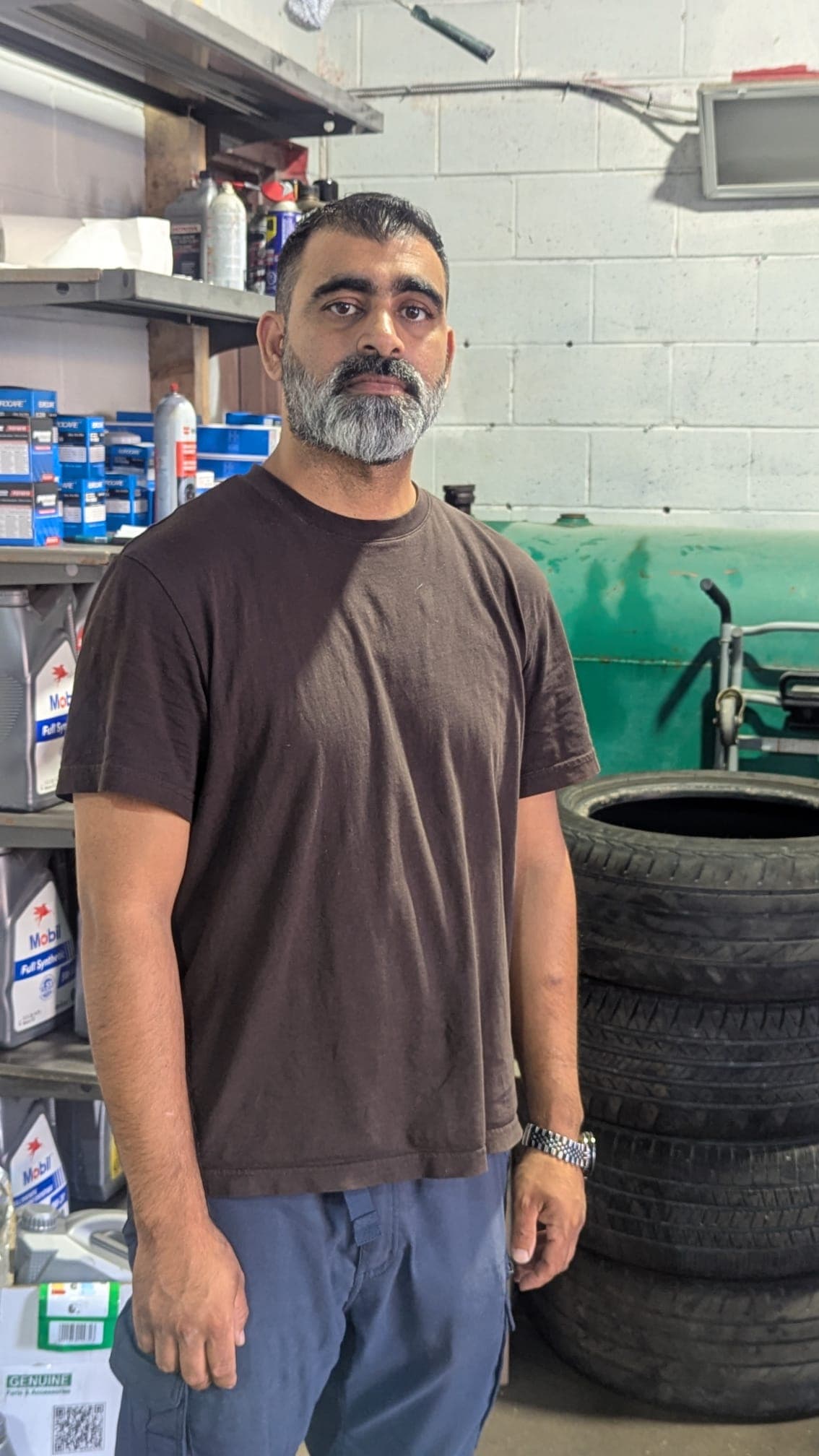 Rickey, owner of Rexdale Auto Detailing, standing in the shop at 2082 Kipling Ave in Etobicoke